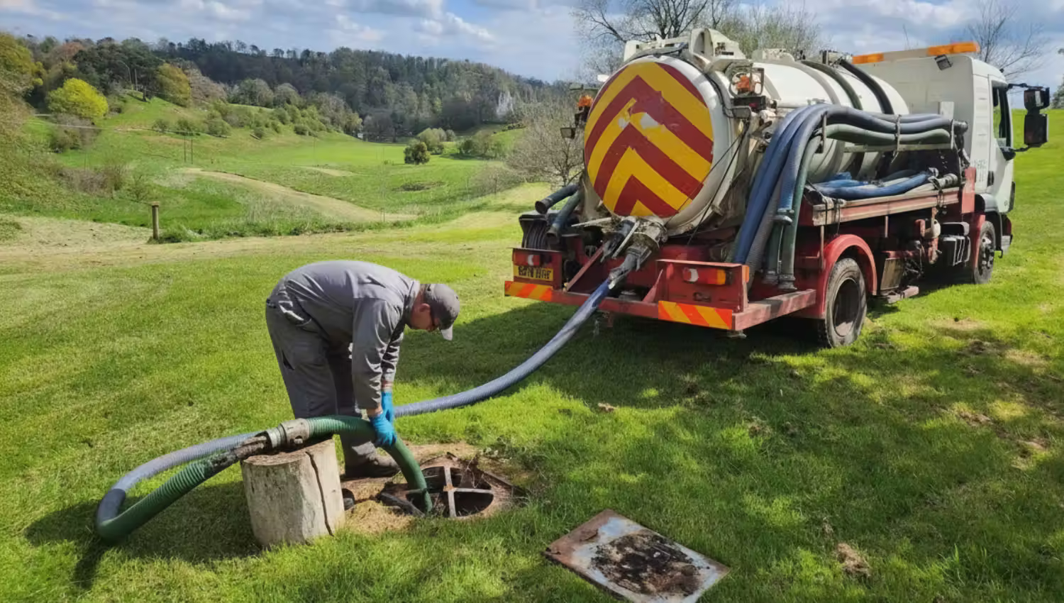 technician emptying septic tank
